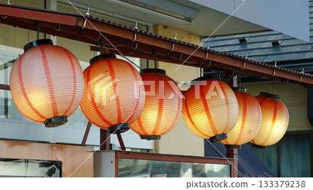 Traditional oriental lights hanging in front of a Japanese store 133379238