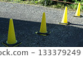 Yellow traffic cones on asphalt 133379249