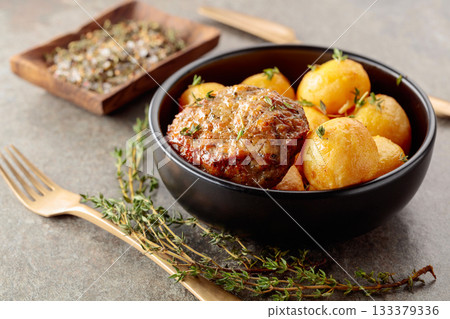 Roasted potatoes with cutlet and thyme. Roasted potatoes with cutlet and thyme. 133379336