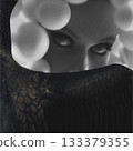 Sensual woman with bubble headpiece and bird wing covering her mouth portrait 133379355