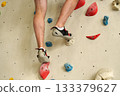 Feet on climbing wall in indoor gym 133379627