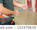 Man tying safety knot for indoor climbing 133379630