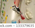 Feet on climbing wall in indoor gym 133379635