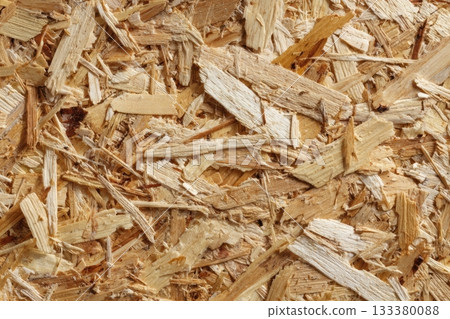 Wood chips spread out in a textured pattern on surface 133380088