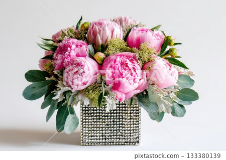 Beautiful pink peony arrangement in a decorative vase Beautiful pink peony arrangement in a decorative vase 133380139