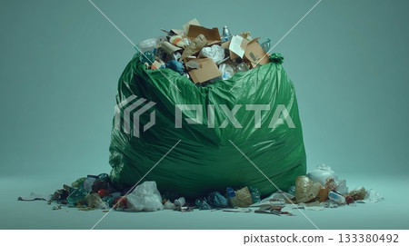 Overflowing green trash bag filled with household waste 133380492