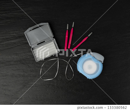 Dental floss, orthodontic wax box and interdental brushes top view. Dental hygiene set Dental floss, orthodontic wax box and interdental brushes top view. Dental hygiene set 133380562