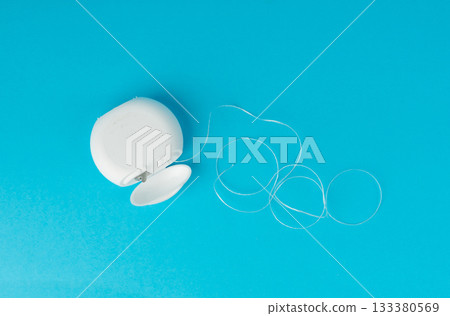 Dental floss plastic container top view. Tooth care string, oral healthcare floss packaging Dental floss plastic container top view. Tooth care string, oral healthcare floss packaging 133380569