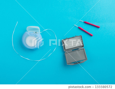 Dental floss, orthodontic wax box and interdental brushes top view. Dental hygiene set 133380572