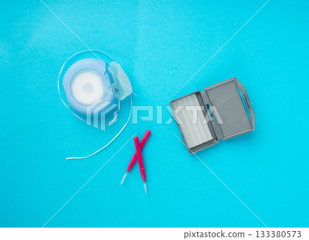 Dental floss, orthodontic wax box and interdental brushes top view. Dental hygiene set Dental floss, orthodontic wax box and interdental brushes top view. Dental hygiene set 133380573