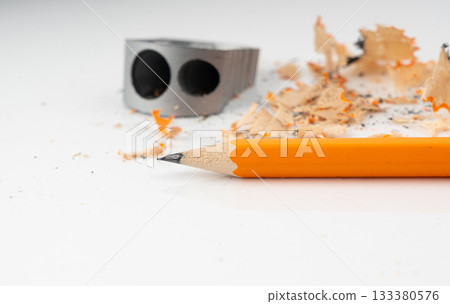Sharpening pencils. Yellow wooden graphite pencils with erasers, pencil shavings 133380576
