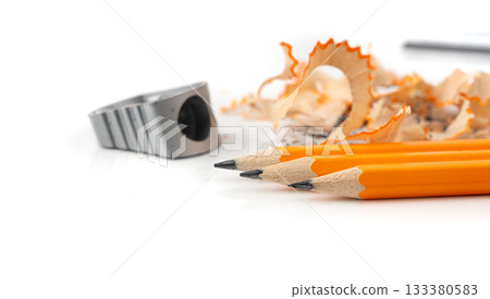 Sharpening pencils. Yellow wooden graphite pencils with erasers, pencil shavings Sharpening pencils. Yellow wooden graphite pencils with erasers, pencil shavings 133380583
