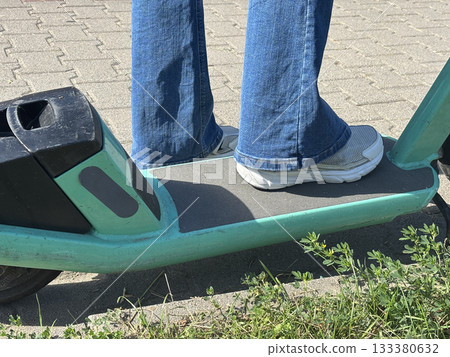 Close up feet on electric scooter Close up feet on electric scooter 133380632