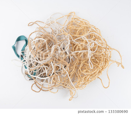 String piece isolated, jute rope fragment, part of packaging cord knots, eco-friendly natural rope 133380690