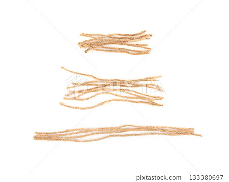 String piece isolated, jute rope fragment, part of packaging cord knots, eco-friendly natural rope 133380697