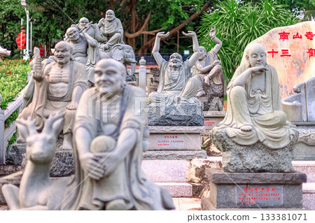 Stone sculptures of Buddhist monks in Nanshan Park, China. General view, daytime, summer 133381071