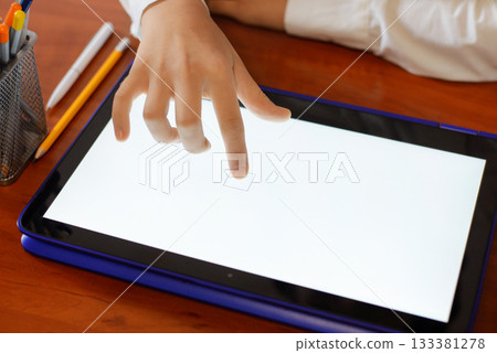 Primary school girl using tablet computer in classroom Primary school girl using tablet computer in classroom 133381278