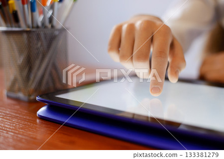 Young learner using convertible laptop in classroom. Using technologies in primary school Young learner using convertible laptop in classroom. Using technologies in primary school 133381279
