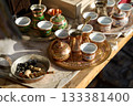 Traditional Bosnian handmade coffee sets on sale. Copper cezves, porcelain cups, and matching accessories. Bascarsija bazaar in Sarajevo. 133381400