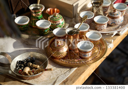 Traditional Bosnian handmade coffee sets on sale. Copper cezves, porcelain cups, and matching accessories. Bascarsija bazaar in Sarajevo. Traditional Bosnian handmade coffee sets on sale. Copper cezves, porcelain cups, and matching accessories. Bascarsija bazaar in Sarajevo. 133381400