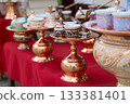 Traditional Bosnian handmade coffee sets on sale. Copper cezves, porcelain cups, and matching accessories. Bascarsija bazaar in Sarajevo. 133381401