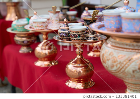 Traditional Bosnian handmade coffee sets on sale. Copper cezves, porcelain cups, and matching accessories. Bascarsija bazaar in Sarajevo. Traditional Bosnian handmade coffee sets on sale. Copper cezves, porcelain cups, and matching accessories. Bascarsija bazaar in Sarajevo. 133381401