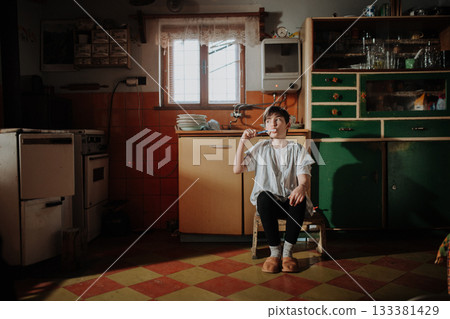 Girl brushing teeth in a modest home. Girl brushing teeth in a modest home. 133381429