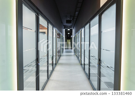 Long Hallway With Glass Doors Leading to Another Room Long Hallway With Glass Doors Leading to Another Room 133381460