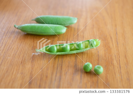 Peeling green peas 133381576