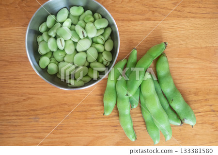 Peeling broad beans Peeling broad beans 133381580