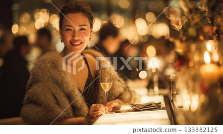 Portrait of a smiling woman in a glamorous night scene | Enjoying a luxurious adult time with champagne 133382125