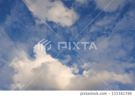 Blue sky with white fluffy cumulus clouds on sunny day Blue sky with white fluffy cumulus clouds on sunny day 133382396