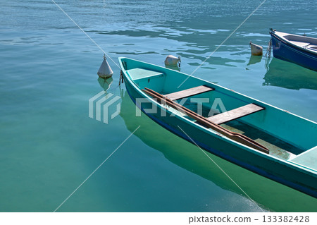 Pleasure launch boat in turquoise lake water Pleasure launch boat in turquoise lake water 133382428
