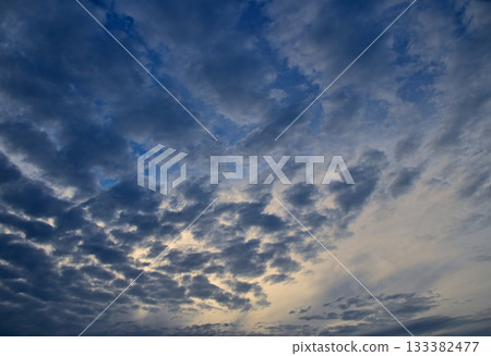 Dark patchy clouds covering blue sky at twilight 133382477