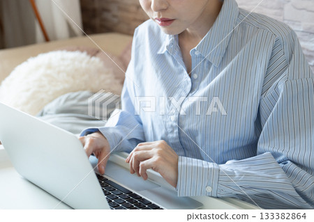 Woman using a computer in the room [parts cut] 133382864