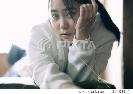 A high school girl lying down and relaxing at home A high school girl lying down and relaxing at home 133383465