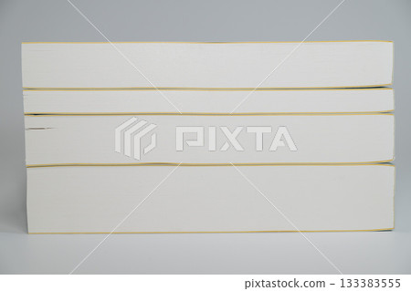 Side of a stack of white books Side of a stack of white books 133383555