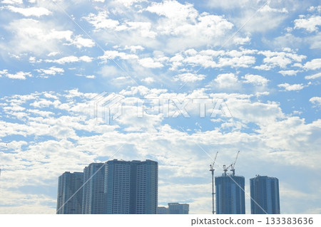 High-rise apartment buildings spread out against the blue sky 133383636