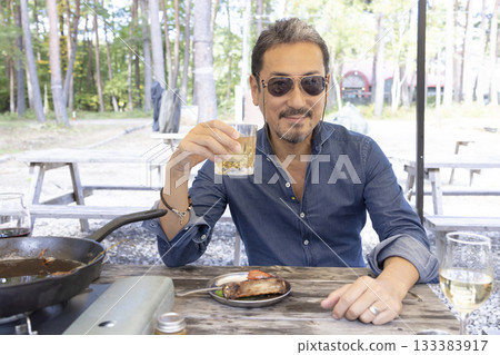 Family having a BBQ at a campsite 133383917