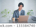 A man in office casual clothes having a meeting while drinking coffee 133384740
