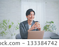 A man in office casual clothes having a meeting while drinking coffee 133384742