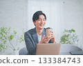 A man in office casual clothes having a meeting while drinking coffee 133384743