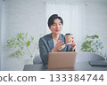 A man in office casual clothes having a meeting while drinking coffee 133384744