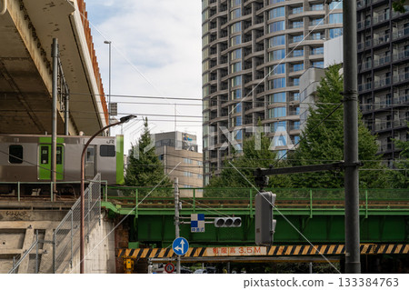 Train passing over a bridge in a modern Japanese city Train passing over a bridge in a modern Japanese city 133384763
