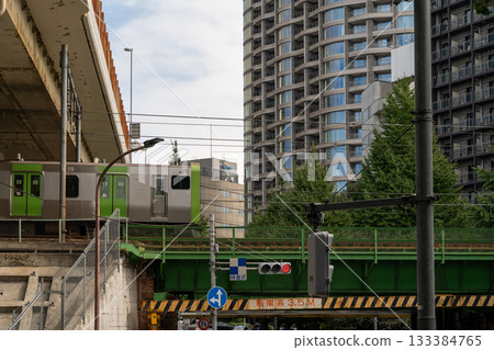 Train passing over a bridge in a modern Japanese city Train passing over a bridge in a modern Japanese city 133384765