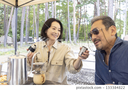 Couple enjoying coffee at campsite Couple enjoying coffee at campsite 133384822