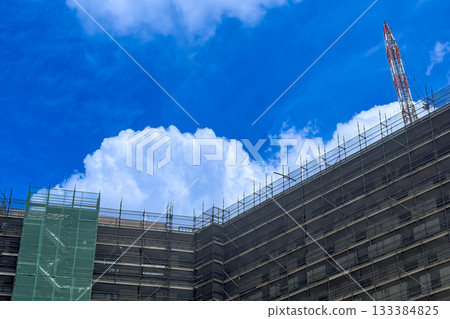 White fluffy Cumulus clouds forming over a construction site White fluffy Cumulus clouds forming over a construction site 133384825