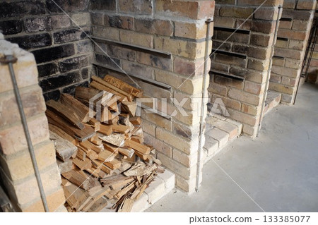 Firewood stacked in the campsite kitchen Firewood stacked in the campsite kitchen 133385077