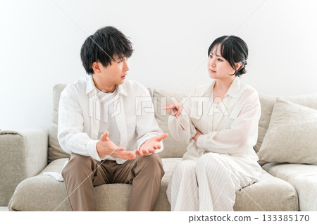 A couple fighting, arguing, and lecturing in the living room (married couple quarrel) 133385170