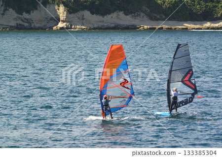 August 21, 2023, Zushi/Hayama, Kanagawa Prefecture: A colorful tandem windsurfer glides across the ocean. 133385304
